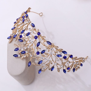 Detailed close-up of bridal leaf crown with navy blue crystals and gold finish