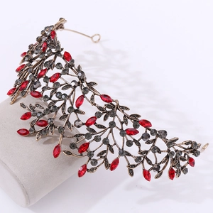 Detailed close-up of Baroque vintage bronze bridal tiara with red and grey rhinestones