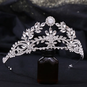 Close-up detail of silver bridal crown featuring leaf motifs and sparkling zircon crystals