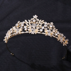 Close-up detail of golden bridal headband with crystals and leaf-shaped rhinestones
