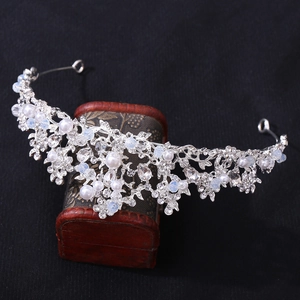 Silver bridal crown with handmade pearls and sparkling rhinestones for wedding hairstyles