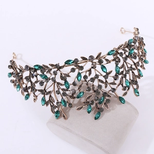 Vintage Baroque crown featuring antique bronze leaves and emerald green gemstones