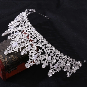 Macro detail of bridal crown with 3A zircons and silver alloy floral patterns on wooden box