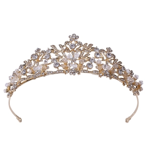 Macro detail of bridal crown featuring leaf textures, rhinestones and crystal beads