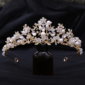 Detailed craftsmanship of silver branch tiara with pearls and crystals on dark backdrop