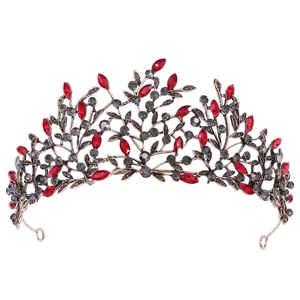 Detail of vintage bronze leaves tiara with red marquise gems and black rhinestones