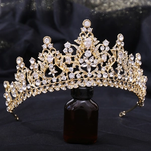 Detailed view of luxury bridal crown with golden base and symmetric baroque zircon patterns