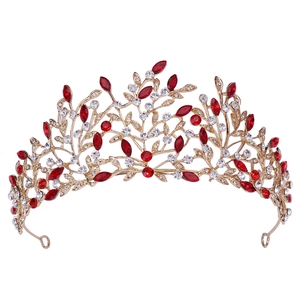Detail of golden leaf crown featuring marquise cut red crystals and clear rhinestones