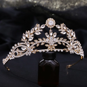 Macro shot of gold bridal tiara featuring leaf-shaped alloy designs and sparkling zircons