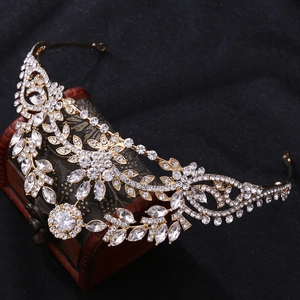 Macro detail of bridal crown with gold leaves and cubic zirconia on vintage jewelry box