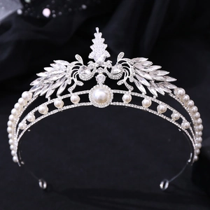 Close-up of luxury bridal crown with AAA zircons and large center pearl on silver frame