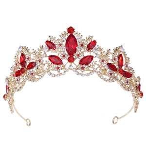 Detailed macro view of vintage gold bridal tiara with red marquise crystals and intricate filigree