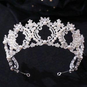 Detailed macro view of silver wedding crown with baroque pearls and luxury crystals