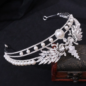 Detailed view of silver wedding crown with AAA cubic zirconia, pearls and peacock motif
