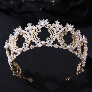 Macro shot of luxury Baroque bridal crown with gold metal filigree and white pearls