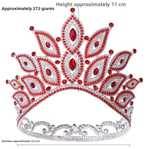 Detailed front view of silver Baroque crown with red rhinestones and crystal leaf motifs