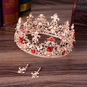 Detailed macro of Baroque gold bridal tiara and earrings with red gems and white pearls