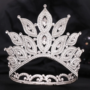 Regal silver bridal crown featuring sparkling marquise rhinestones on a dark fabric background