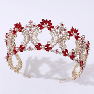 Detailed view of baroque golden bridal crown with red rhinestones and pearls