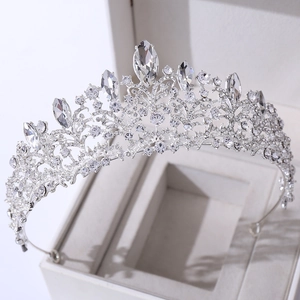 Macro shot of silver bridal tiara with round and marquise crystals on jewelry box