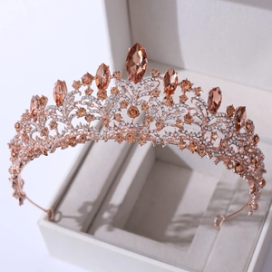 Macro view of rose gold crown with amber rhinestones and crystal bridal detailing