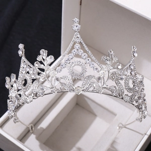 Macro shot of silver wedding tiara with crystal flowers and tower-shaped baroque details