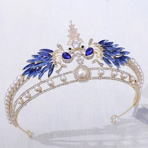 Close-up of golden bridal crown with blue gemstones and sparkling white rhinestones