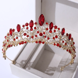 Close-up of rose gold bridal crown with red marquise crystals and white rhinestones