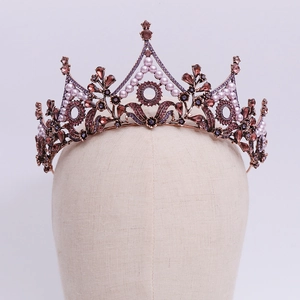 Detail of baroque bridal crown with dark crystals and pearls on bronze leaf metalwork