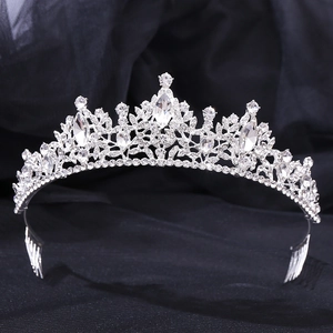 Detailed close-up of a silver leaf bridal crown with sparkling rhinestones and hair comb pins