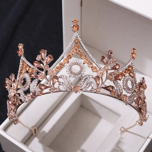 Macro detail of rose gold baroque bridal crown with champagne crystals in a white box