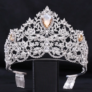 Close-up of Baroque silver crown with amber teardrop crystal and rhinestone details