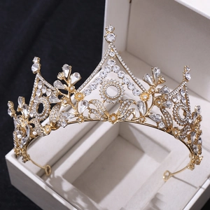 Macro shot of gold baroque bridal crown with crystals in jewelry box for weddings