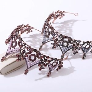 Close-up of vintage baroque crowns featuring intricate filigree metalwork and crystals