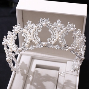 Macro shot of luxurious silver bridal crown with white pearls and sparkling crystals