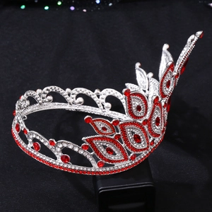 Detail of Baroque bridal crown with red gemstones and crystals on a dark background