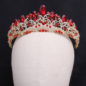 Detailed macro view of luxurious rose gold tiara with red crystals and rhinestones