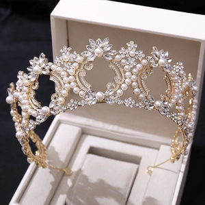 Close-up of a luxury Baroque bridal crown with white pearls and crystals in a jewelry box