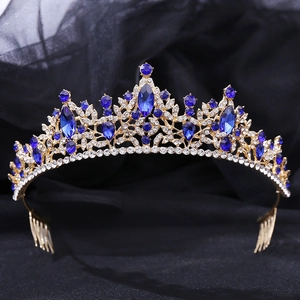 Detailed macro view of golden leaf tiara with dark blue gemstones and sparkling rhinestones