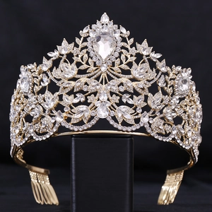 Close-up of golden Baroque bridal crown with crystals and central pear-shaped gemstone