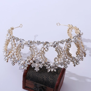 Detailed view of luxury baroque bridal crown with crystals and pearls on dark wood box