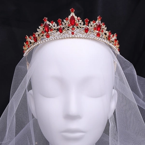 Regal golden bridal crown with sparkling red rhinestones and crystals on a white veil