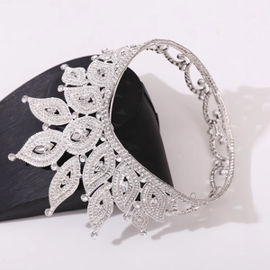 Close-up of silver bridal crown with sparkling rhinestones on a black display stand