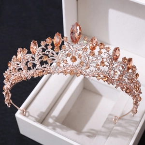 Detailed close-up of rose gold bridal crown with champagne crystals and intricate rhinestones
