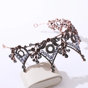 Detailed close-up of vintage bronze crown with grey crystal leaves and dark grey rhinestones
