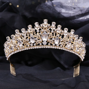 Detailed macro view of golden bridal tiara with green crystals and secure hair comb teeth