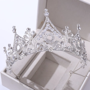 Macro detail of silver floral crown with sparkling crystals on a gray jewelry box