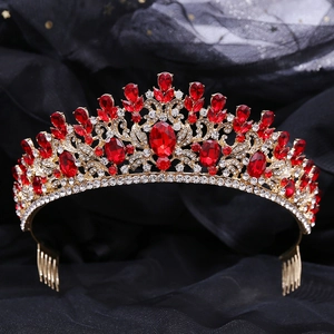 Detailed macro view of baroque gold crown with red gemstones and secure side combs