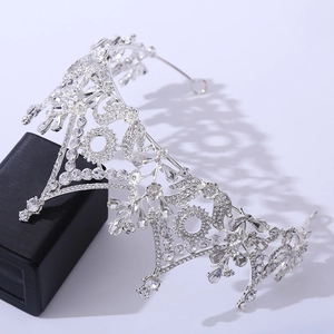 Close-up of the intricate silver floral patterns and crystal inlay of the bridal crown