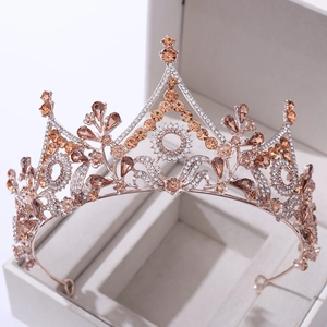 Luxury Baroque floral crystal crown in rose gold with champagne rhinestones on gray display